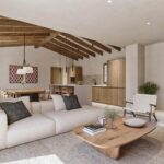 Wohnzimmer mit ecrufarbenem Sofa, Sesseln mit Seilgeflecht, Couchtisch aus Holz und Küche im Hintergrund