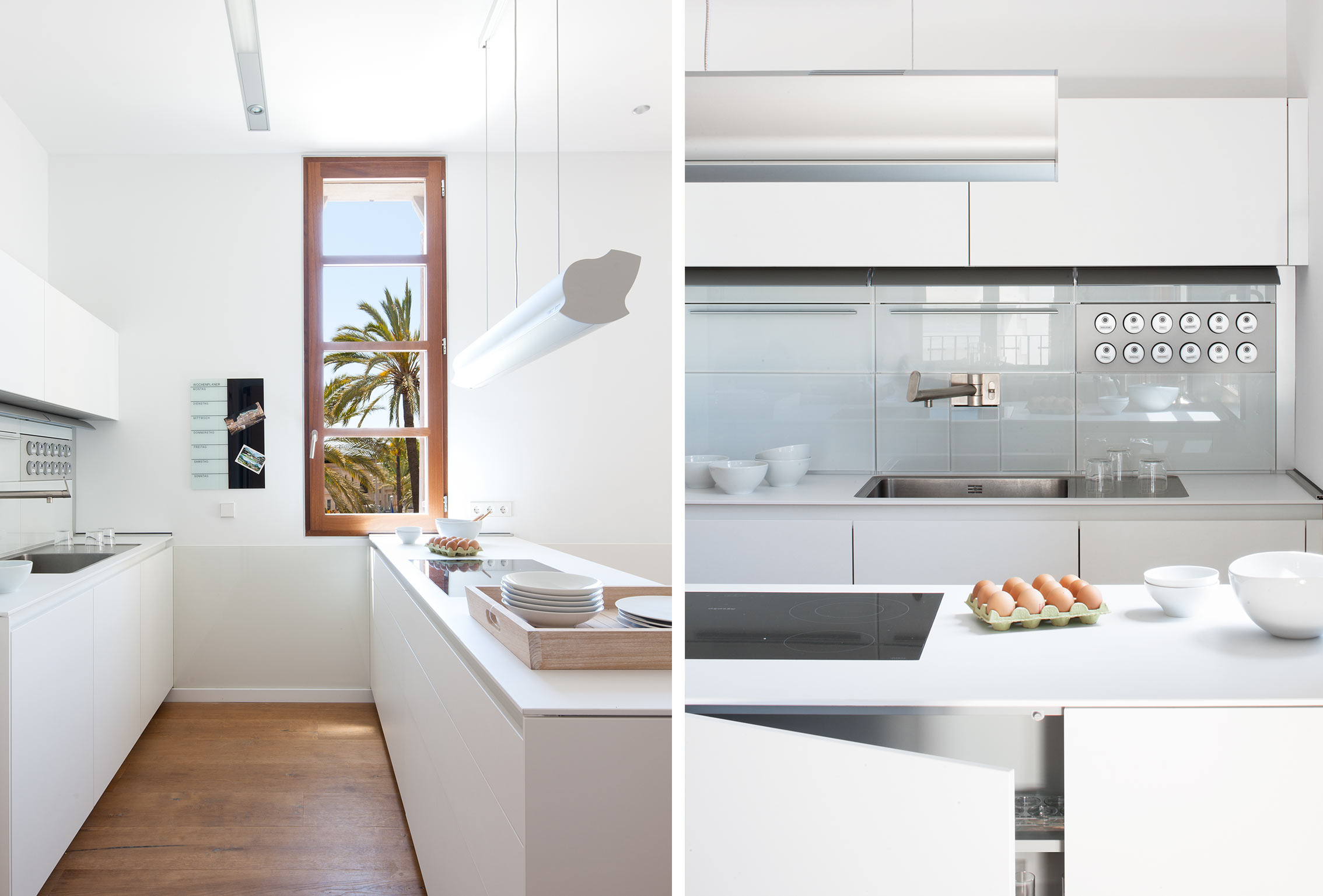 Cocina blanca con isla y ventana a palmeras, junto a detalle de fregadero y frontal de cristal