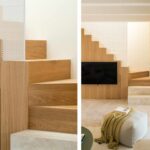 Treppe aus hellem Holz mit weißem perforiertem Paneel und Wohnzimmer mit Steinboden und integriertem Fernseher