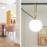 Round table with pink chairs on parquet and detail of a spherical lamp with gold fittings