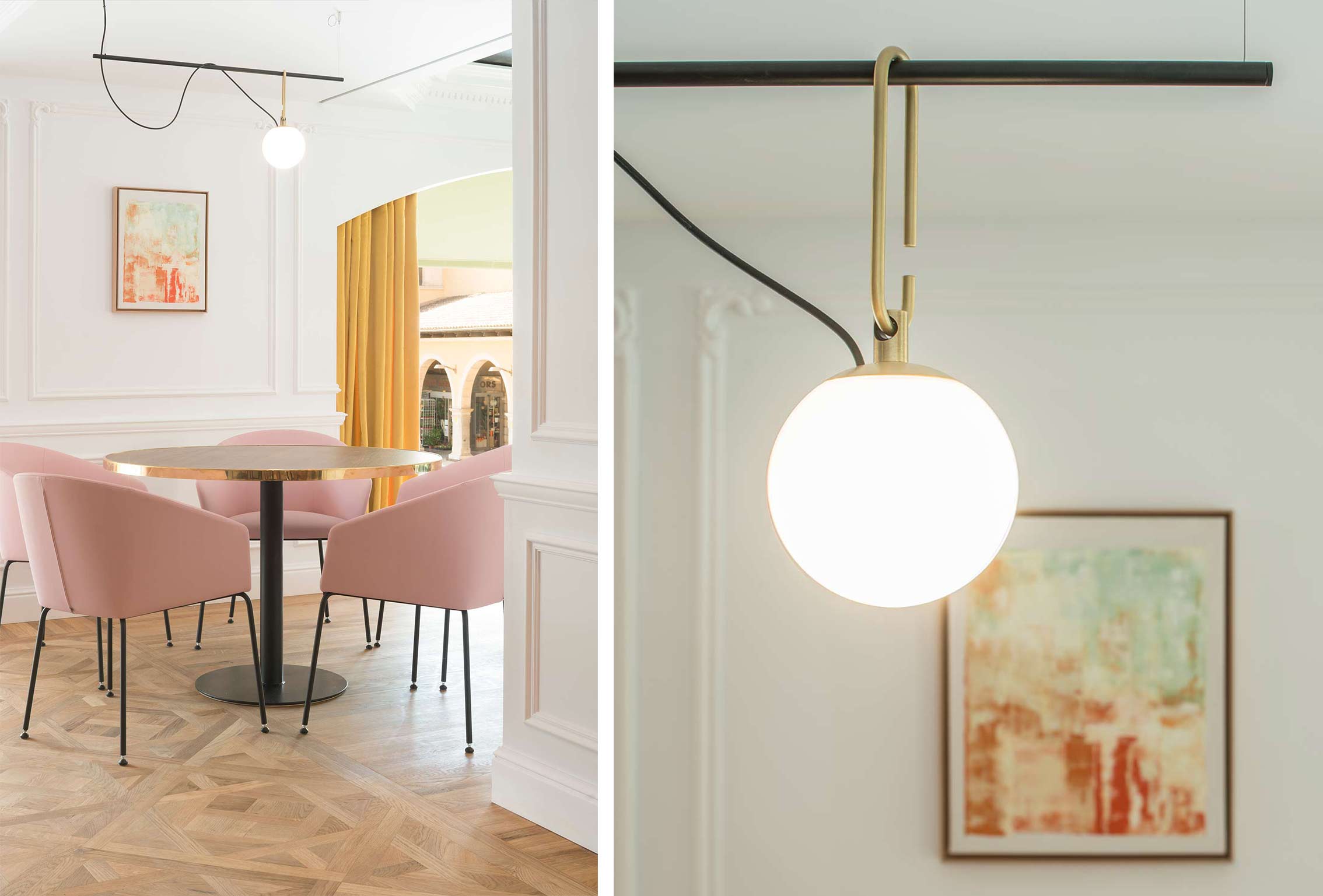 Round table with pink chairs on parquet and detail of a spherical lamp with gold fittings