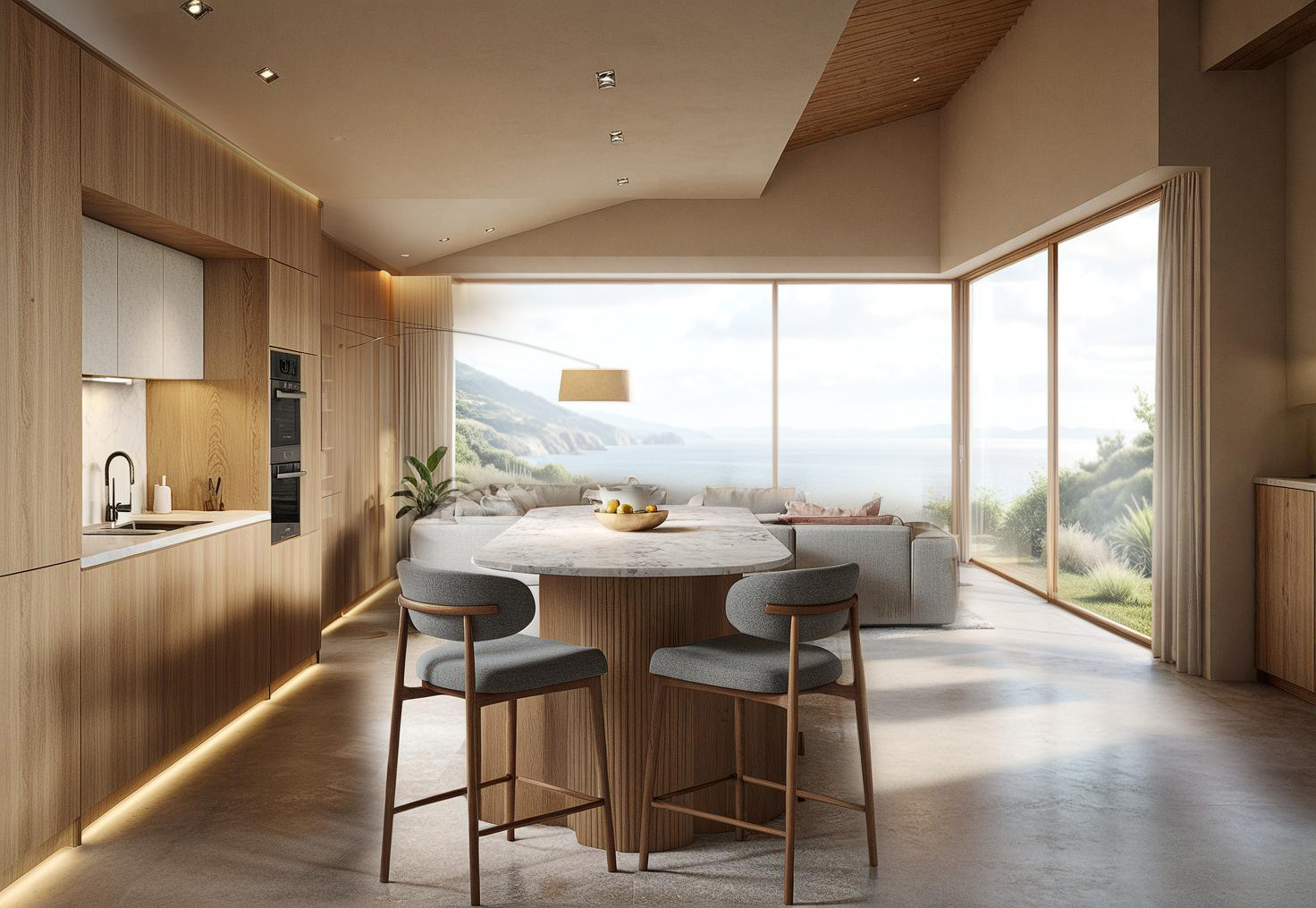 Light wood kitchen with an oval marble-topped island, grey stools and sea views