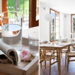 Jarra de cristal, servilletas de lino y flor rosa sobre bandeja de madera, junto al comedor luminoso
