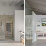 Bathroom with glass shower, pale stone cladding, timber towel ladder and basin on a shelf