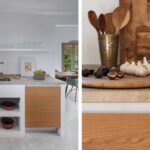 White masonry kitchen with timber fronts and stone worktop, with a detail of figs and garlic