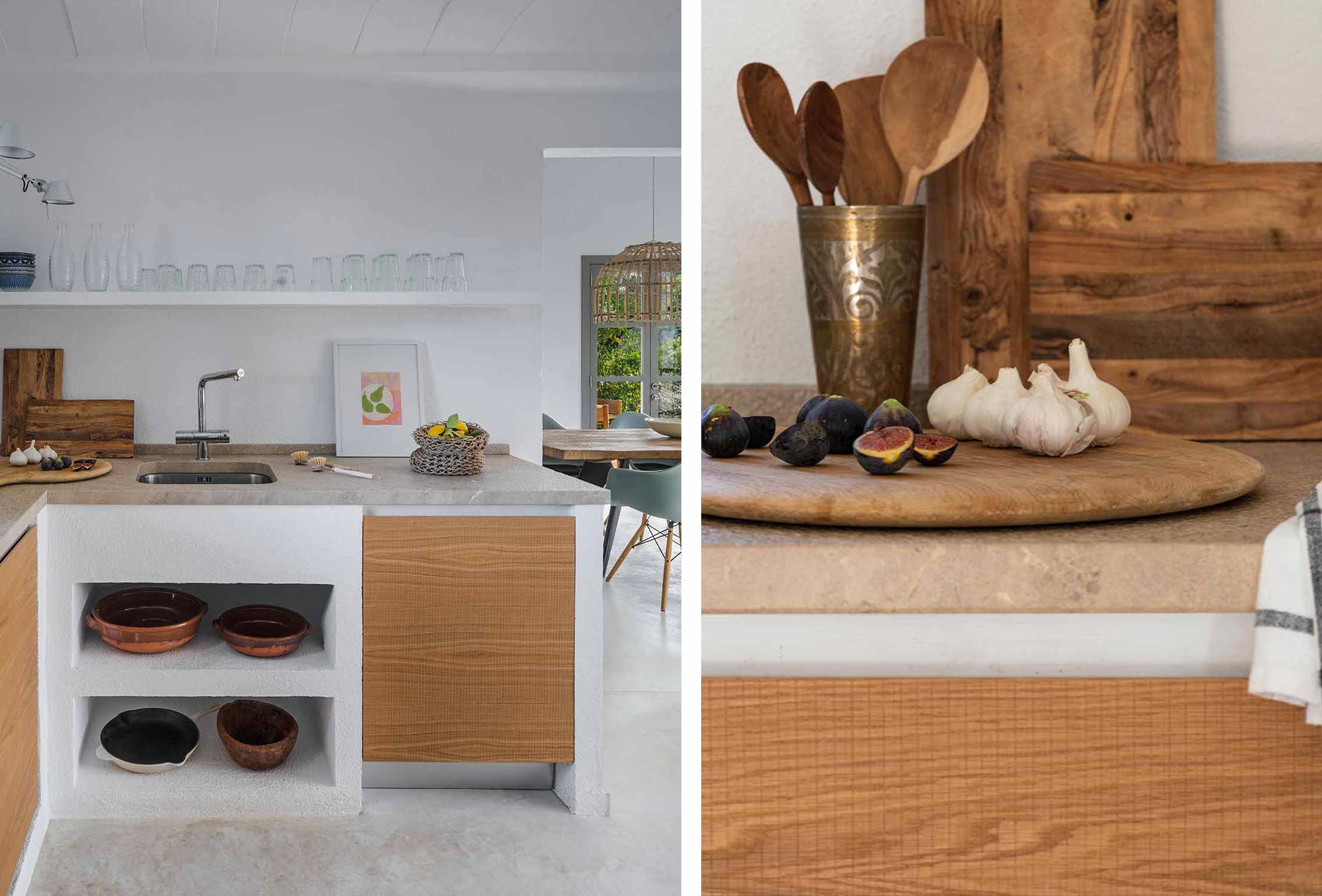 White masonry kitchen with timber fronts and stone worktop, with a detail of figs and garlic