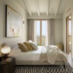 General view of the bedroom with white beams, black and white geometric rug and balcony