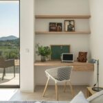 Desk built into a niche with wooden shelves, white cane chair and mountain views