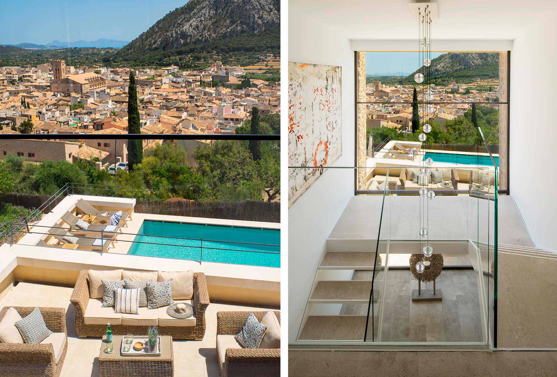 Terraza con sofás de mimbre y vistas al pueblo; a la derecha, escalera de cristal con lámpara colgante.