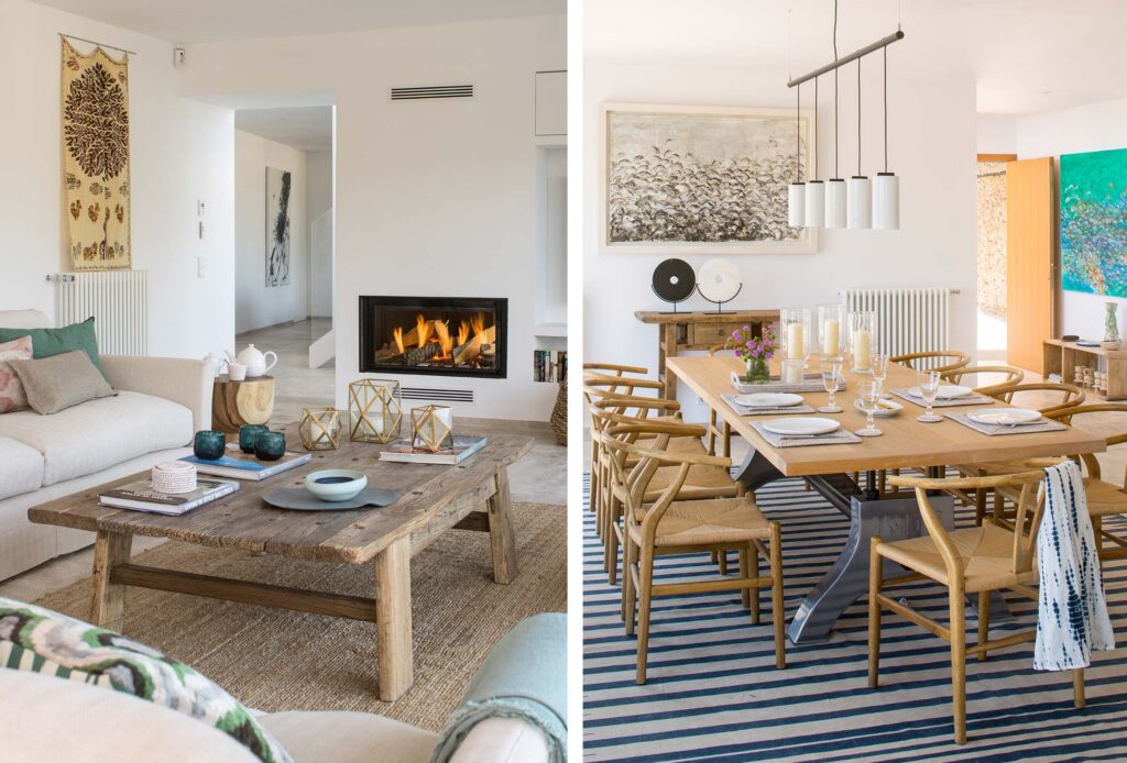 Salón con chimenea encendida y comedor de madera con sillas de asiento trenzado.