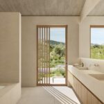 Render of a bathroom with a built-in bath, double washbasin on a timber vanity and a slatted door to the garden