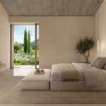 Render of a bedroom with a low bed, television, a potted olive tree and a sliding door to the garden