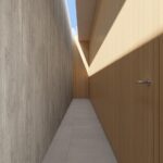Render of a narrow corridor between a grey wall and timber panels, with natural light from above
