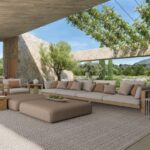 Render of the covered porch with a sofa and armchairs, a pergola with climbing plants and the mountain beyond
