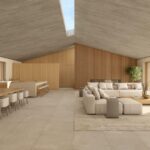 Render of the spacious living and dining area under a pitched ceiling with a skylight, with sofa and long table